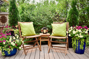 Secluded outdoor oasis at summer Airbnb vacation rental, relaxation in small backyard landscaped garden. Luxury lifestyle relaxing with chilled glass of wine in outdoor cafe seating.