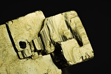 Pyrite collection specimen on black background. Detail close-up macro from peru 