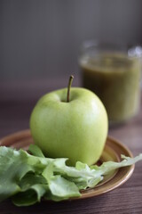 Isolated green fresh apple on a plate and diet drink healthy diet organic food juicy nutrition