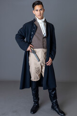 A Regency gentleman holding a flintlock pistol against a studio backdrop