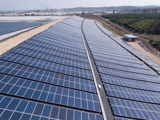 Solar panels installed on a water reservoir bank.