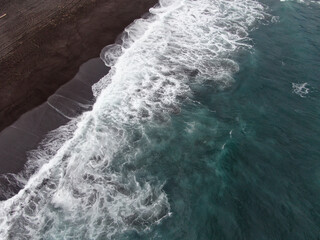 Soft waves and black sand beach. Aerial view drone shot on the Khalaktyrsky beach, Kamchatka.