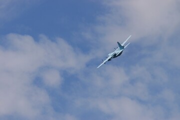 Fototapeta na wymiar Aircraft flying against background of autumn blue sky