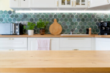 Fototapeta na wymiar blurred kitchen interior and wooden desk space home background