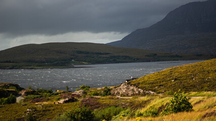 Incoming storm with clouds and waves in a bay in Scotland. Stormy weather at the sea of the...