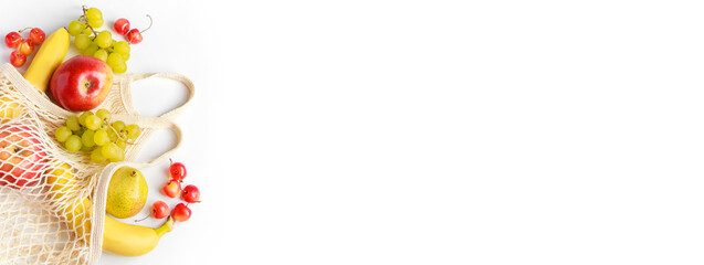 Ripe fruits in eco-friendly mesh bag on white background. Organic vegan food. Trendy string bag. Healthy eating and sustainable lifestyle concept.