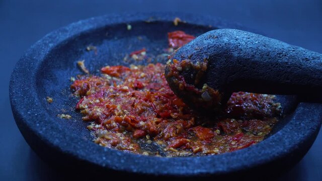 Zoom in red chili sauce in mortar stone