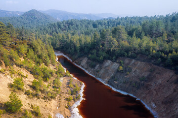 Acidic lake in abandoned open pit of copper mine in Paphos forest, Cyprus. Aerial landscape
