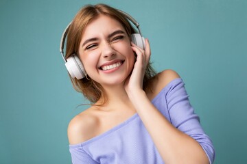 Closeup photo of sexy pretty happy smiling young blonde woman wearing blue crop top isolated over...
