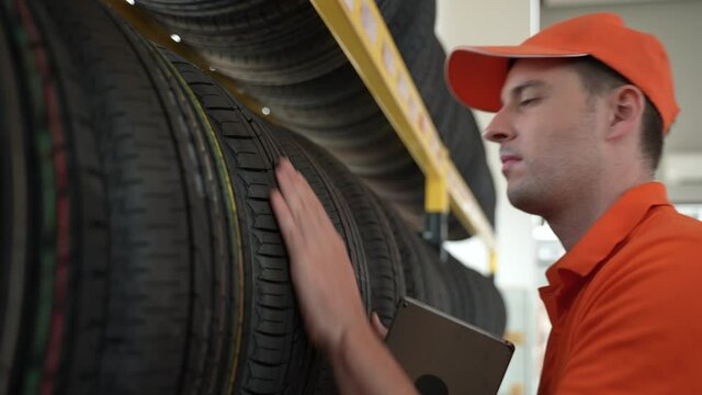 Auto Service Expertise: Technician Advising Customers on Premium Tires and Wheels at a Vehicle Repair Center Focused on Engine Performance