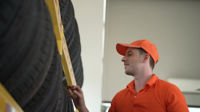 Auto Service Expertise: Technician Advising Customers on Premium Tires and Wheels at a Vehicle Repair Center Focused on Engine Performance