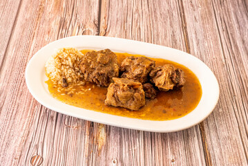 tray of oxtail stew cooked with Spanish recipe accompanied by white rice