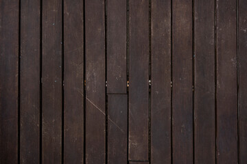 worn deck planks varnished in a dark color.
