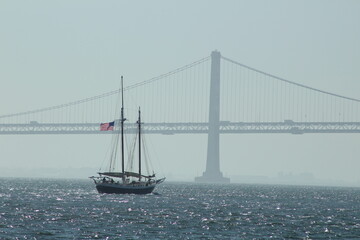 Golden Gate Bridge in mist with boat