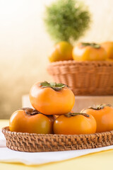 Persimmon fruit on golden background, tropical fruit mostly in Southeast Asia, refreshing and healthy eating sweet taste