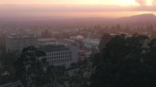 Aerial: Berkeley city skyline at sunset, California, USA