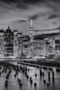Black and white vertical image of lower manhattan and the business and wall street district from across the east River