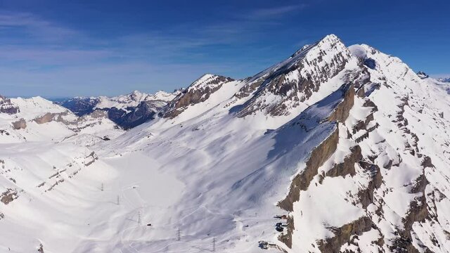 Aerial drone footage of the famous Gemmi pass in the alps in Canton Valais above the Leukerbad station on a sunny winter day in Switzerland. 