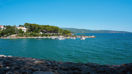 Fototapeta premium View from the city wall to the beach Punta Di Galetto on the Adriatic Sea on the outskirts of the town Krk in Croatia