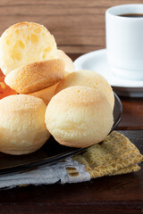 Whole and half cheese bread (pão de queijo) close up.