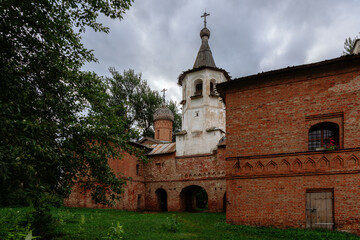 Fototapeta na wymiar View of the Church of St. Michael the Archangel and the Church of the Annunciation of the Most Holy Theotokos on a cloudy summer day, Veliky Novgorod, Novgorod region, Russia