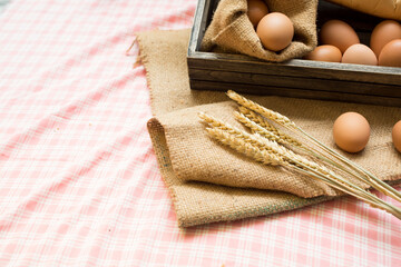 Breakfast and baked bread concept. Fresh fragrant bread and egg on the fabric sack. On wooden table. morning breakfast.
