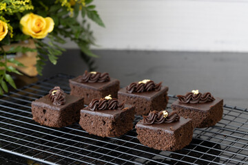 Cubes of chocolate brownie on a cooling rack.