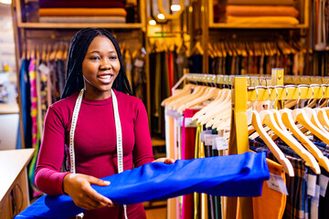 dark skinned business woman salewoman working at textile shop