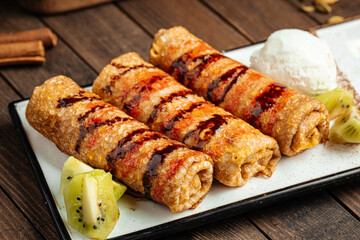 Sweet pancakes dessert with kiwi filling and ice cream