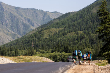 Atmospheric moment in mountains. Hiking tourists with backpack traveler on top of mountains.