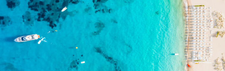 View from above, stunning aerial view of a bathing establishment on a white sand beach bathed by a...