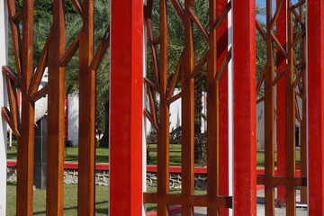 Fototapeta na wymiar Modern red fence with a natural background