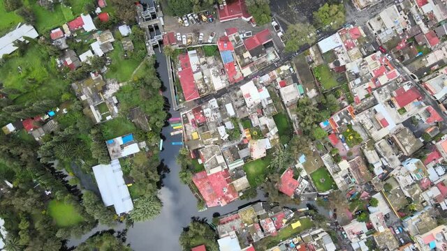 Zenith view of canals of Xochimilco with reflection of clouds in water of canals. Can see small houses and chinampas at 120 meters