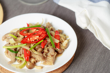 Stir-fried Beef with Oyster Sauce, Thai style food, rich flavor consisting of mushrooms, onions, chilli and spring onions.
