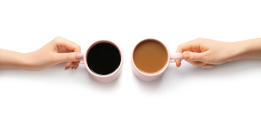 Female hands and cups of coffee on white background