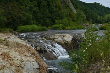 The beautiful natural water flowing river along with the rough rock mountains in Sapporo Japan