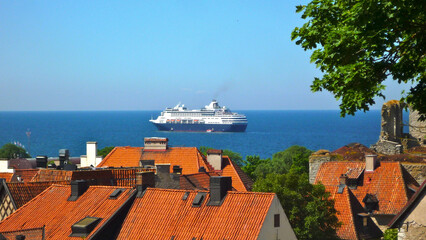 Cruiseships cruise ship liners anchore offshore of old town city skyline of Visby, Gotland in...