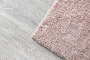 Soft carpet on wooden floor, closeup