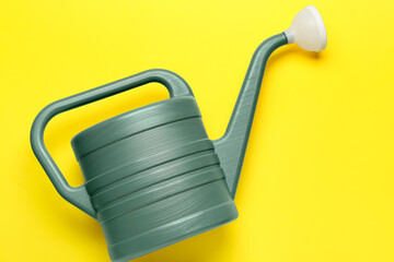Watering can on color background