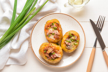 Plate with baked potato on table