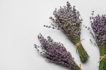 Bouquets of lavender flowers on grey background, closeup