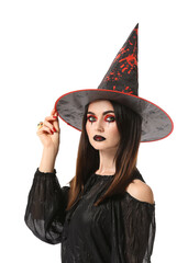 Beautiful woman dressed as witch for Halloween on white background