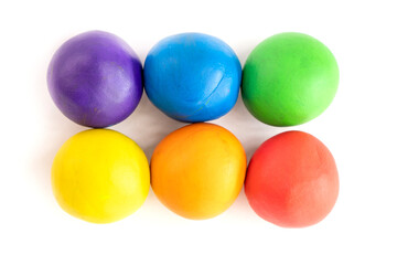 Multicolored circle shape plasticine placed on a white background. Play dough
