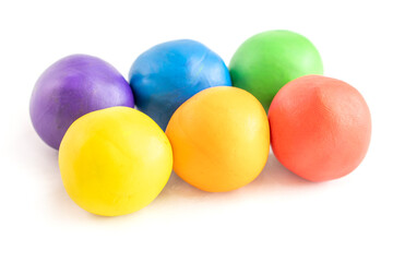 Multicolored circle shape plasticine placed on a white background. Play dough