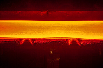 Conveyor belt on which a hot metal sheet lies in soft focus. Continuous hot casting of steel....