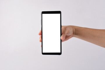 Hand and smartphone with blank white screen and black stylus for writing isolated on white background. 