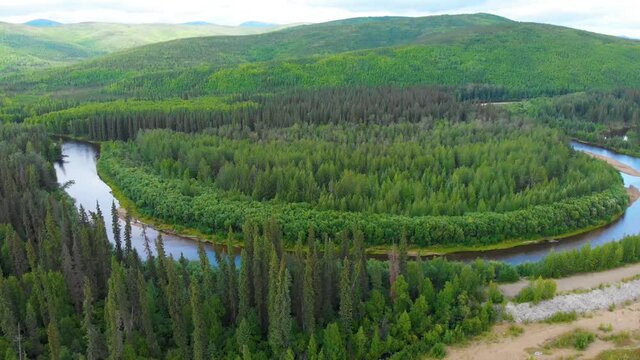 4K Drone Video (truck right shot) of Beautiful Horeshoe Bend in the Chena River as it runs through Pine Tree Covered Mountains near Chena Hot Springs, Alaska in Summertime