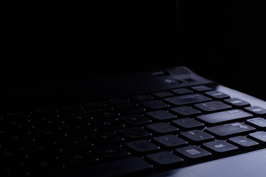 Looks close. Laptop on a black background and little lighting. Simple concept.