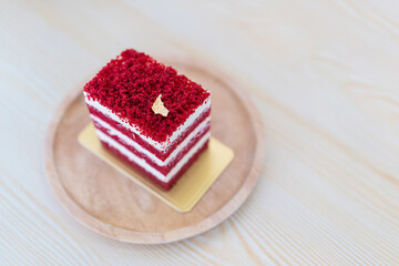 Red velvet cake face cut to texture layers with butter and soft cream on wooden board. Slice of cake. Raspberry cake.