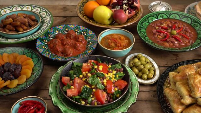 Holiday islamic table with dates, Oriental food and sweets. Eid mubarak. Traditional Middle Eastern cuisine, evening meal. Ramadan iftars marks the end of fasting